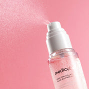MEDICUBE PDRN Pink Collagen Glow Jelly Mist Serum  with mist feature on a pink background