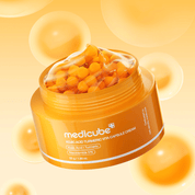 Orange jar of Medicube KOJIC ACID TURMERIC VITA CAPSULE CREAM  with capsules on a yellow background