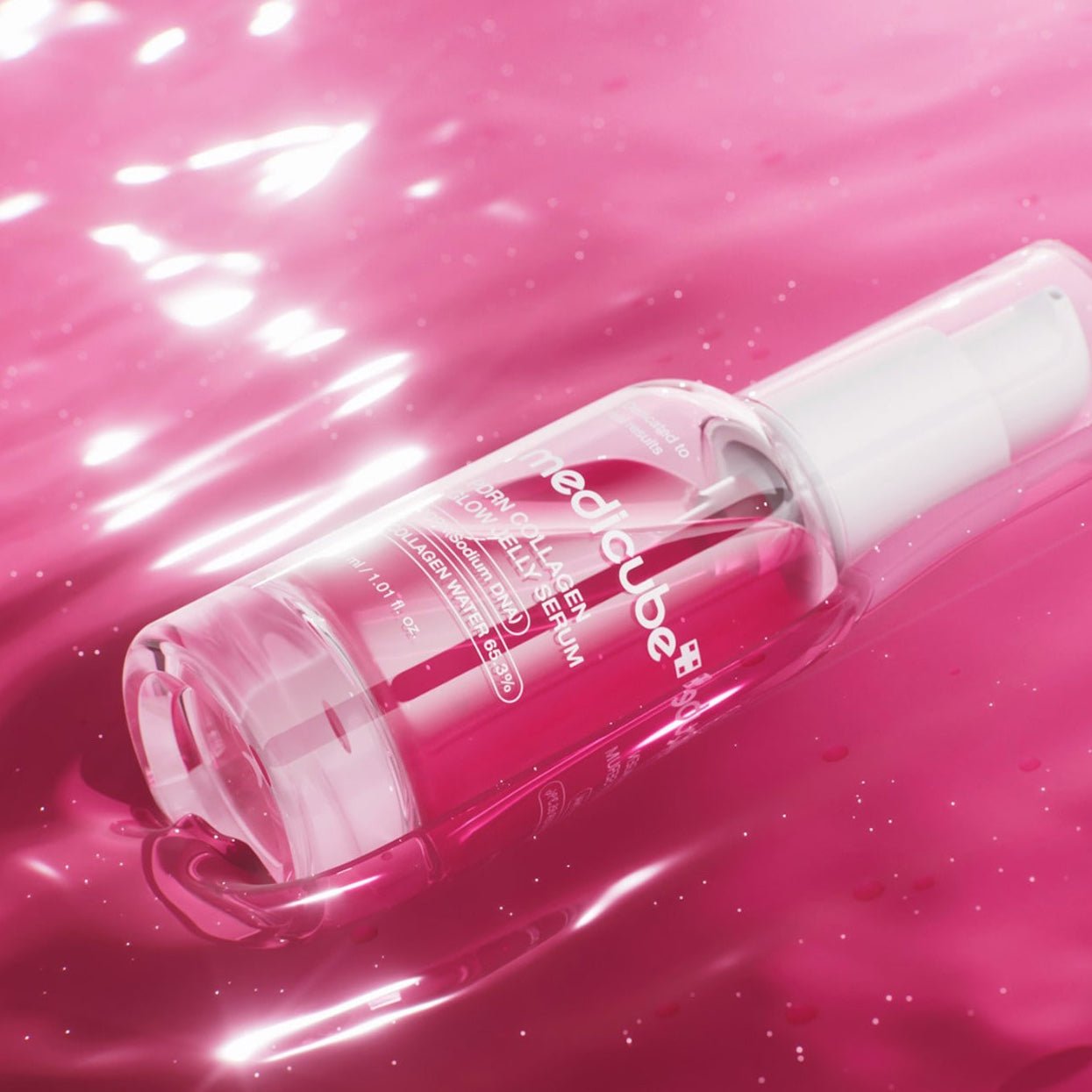 Medicube PDRN Collagen Glow Jelly Serum with red liquid on a pink background