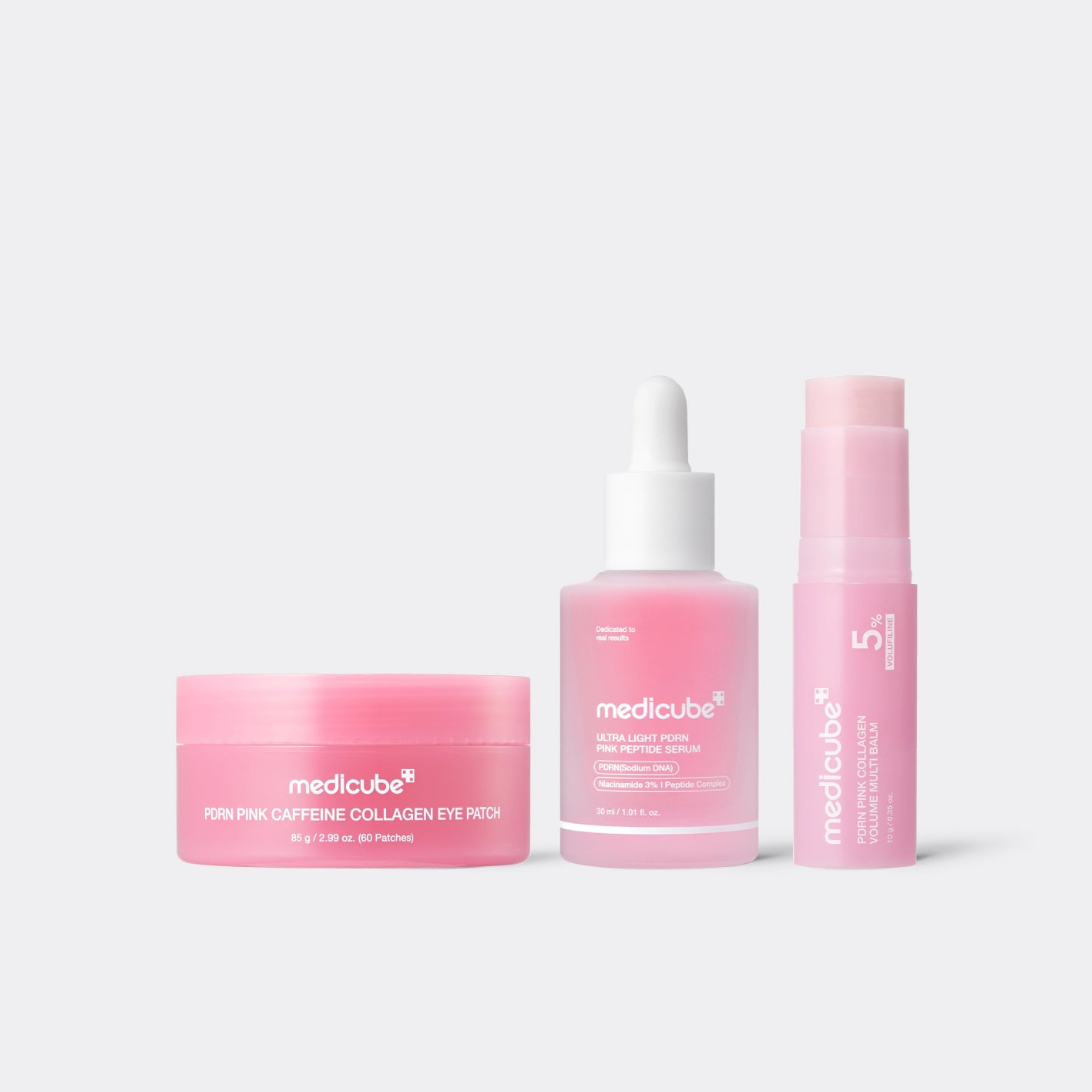 Medicube PDRN Pink Collagen Glass Skin Set – Serum, Eye Patches & Multi Balm on grey background