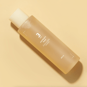 NUMBUZIN No.3 Super Glowing Essence Toner with a beige background