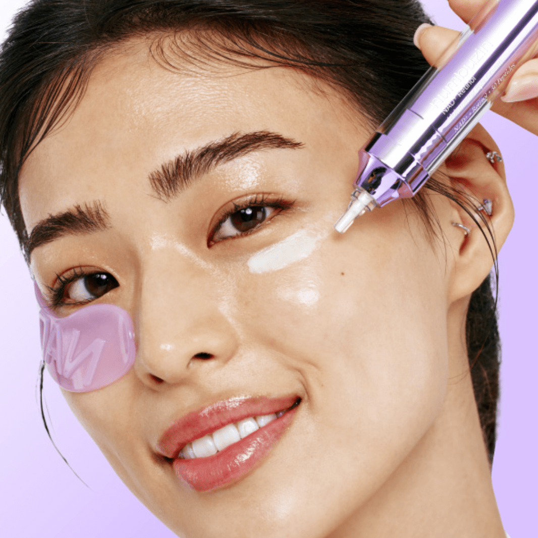  model face close shot with NUMBUZIN No.9 NAD+ Collagen Under Eye Patches (5 Pairs)  under eye and No.9 NAD+ Retinol Volumetox Eye Cream holding