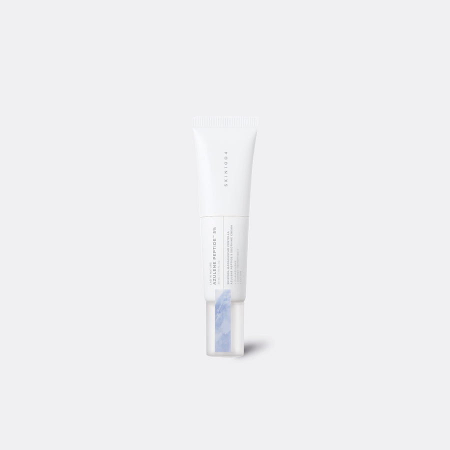 A white squeeze tube of SKIN1004 Madagascar Centella Azulene Peptide 5 Soothing Cream with a clear cap showing a light blue gel inside, centered on a light gray background.