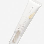A white squeeze tube of SKIN1004 Madagascar Centella NAD 0.1 Cream, featuring a light beige cream smear graphic on the front, set against a clean white background.