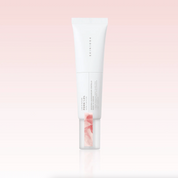 A white squeeze tube of SKIN1004 Madagascar Centella PDRN 1.5 Cream with a clear cap showing pink serum inside, centered on a soft pink gradient background.