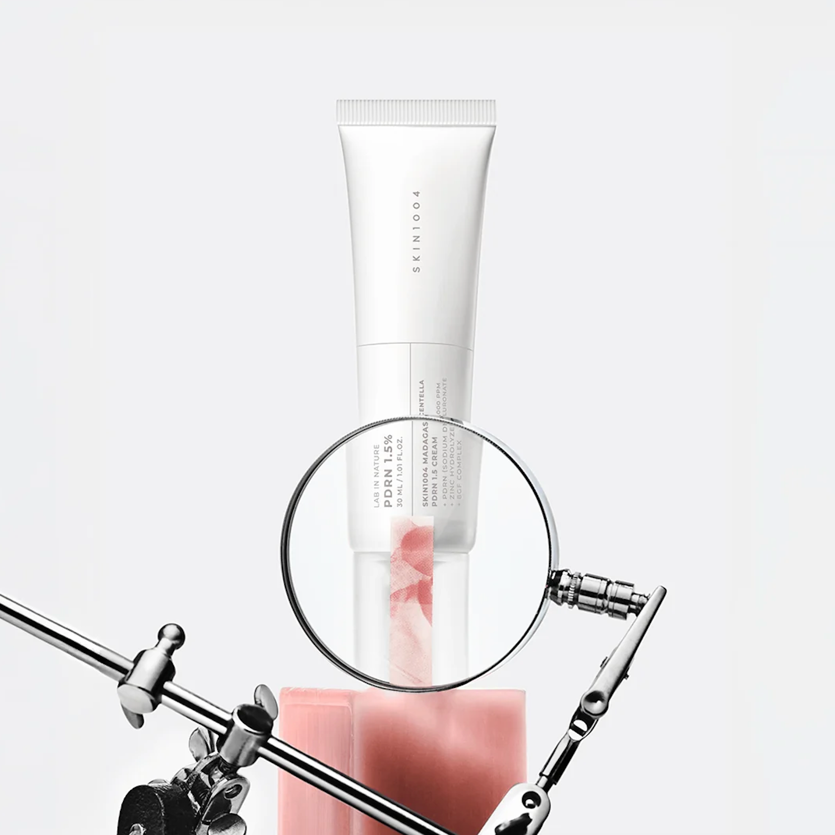 white studio background with metallic stand hardware visible at the bottom.