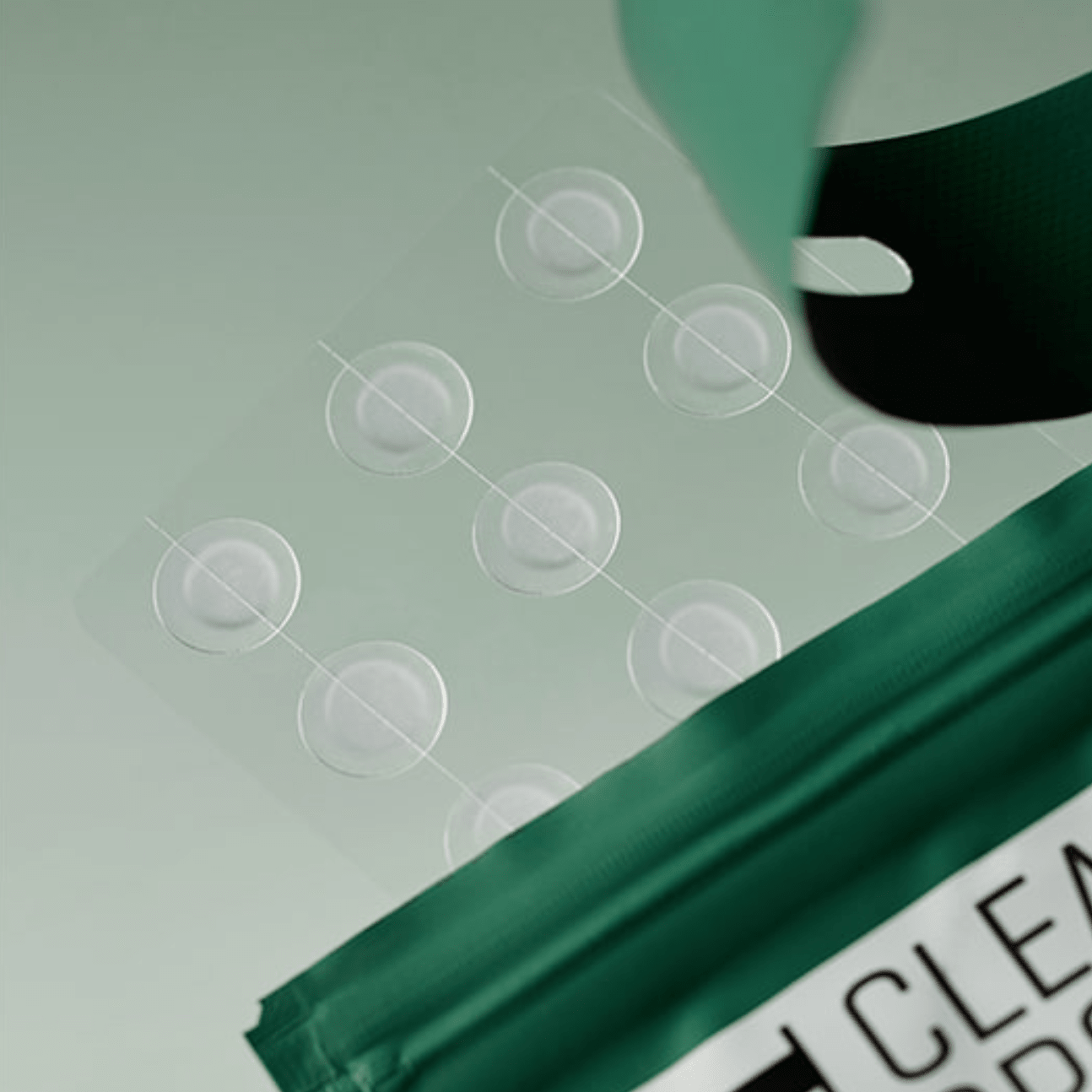 SOME BY MI Clear Spot Patch being applied to a surface with circular clear stickers.