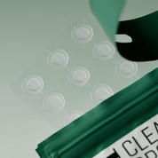 SOME BY MI Clear Spot Patch being applied to a surface with circular clear stickers.