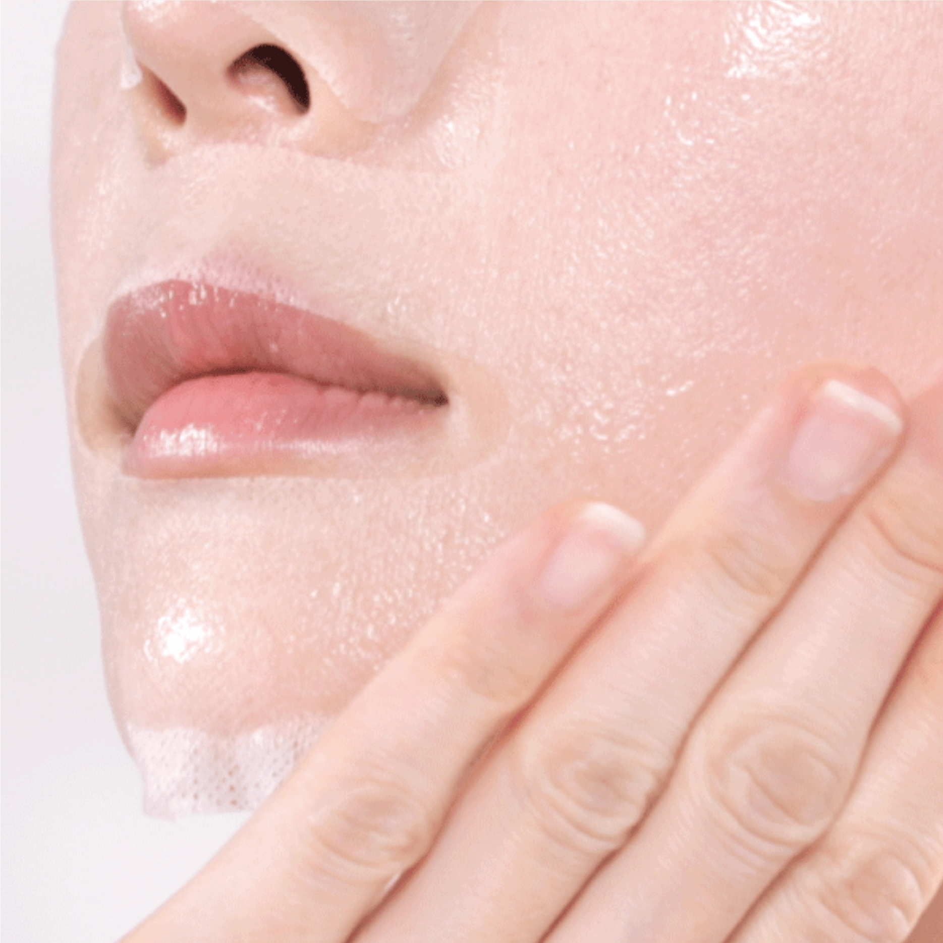 Close-up of a person applying a SOME BY MI Real AHA-BHA-PHA Calming Care Mask to their face.