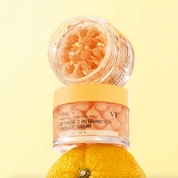 Vitamin C Astaxanthin capsule cream with a lemon on a light yellow background