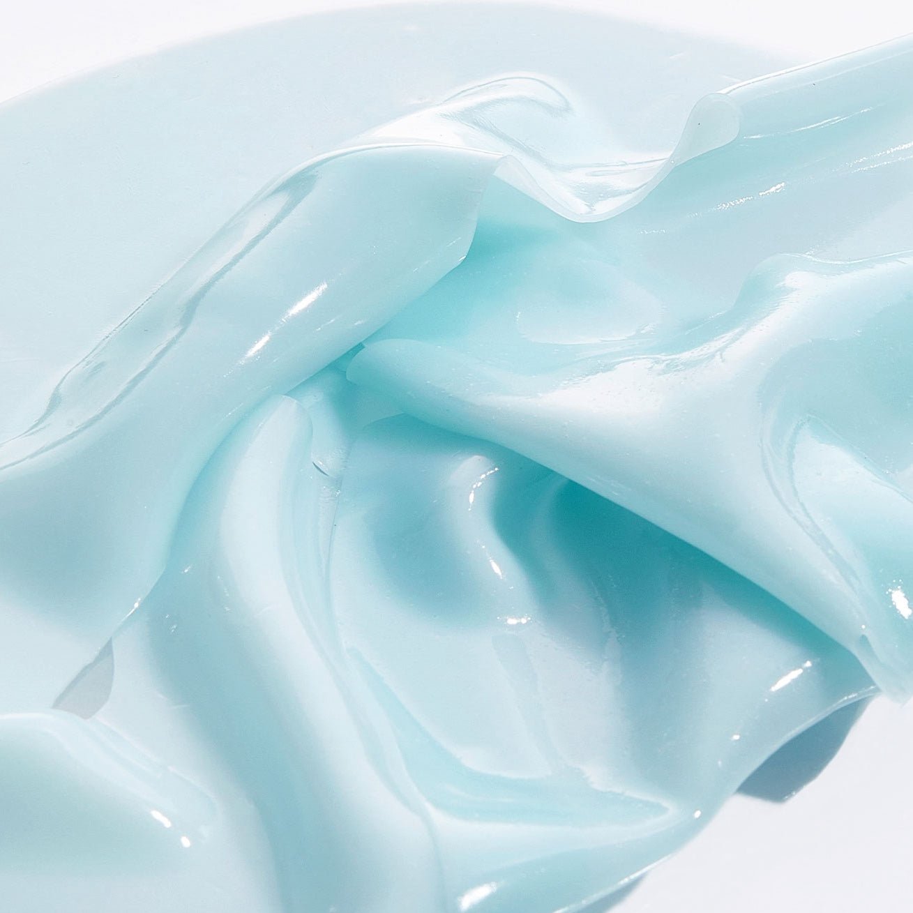 Close-up of light blue, glossy VT COSMETICS PDRN Hydrogel Mask