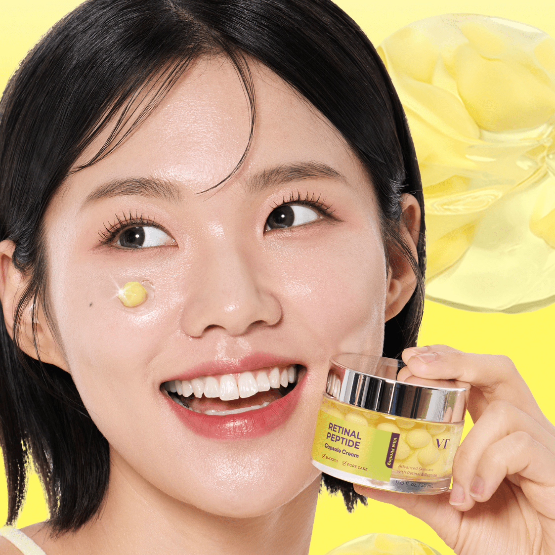 Woman applying VT COSMETICS Retinal Peptide Capsule Cream to her face with a jar of cream in hand on a yellow background