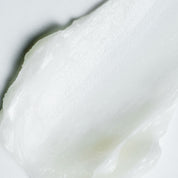Close-up of smooth, white cream VT PDRN Essence Stick Balm on a light background
