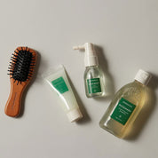 AROMATICA Rosemary Scalp Scaling Trial Kit  including a brush, tube, spray bottle, and bottle on a neutral background.