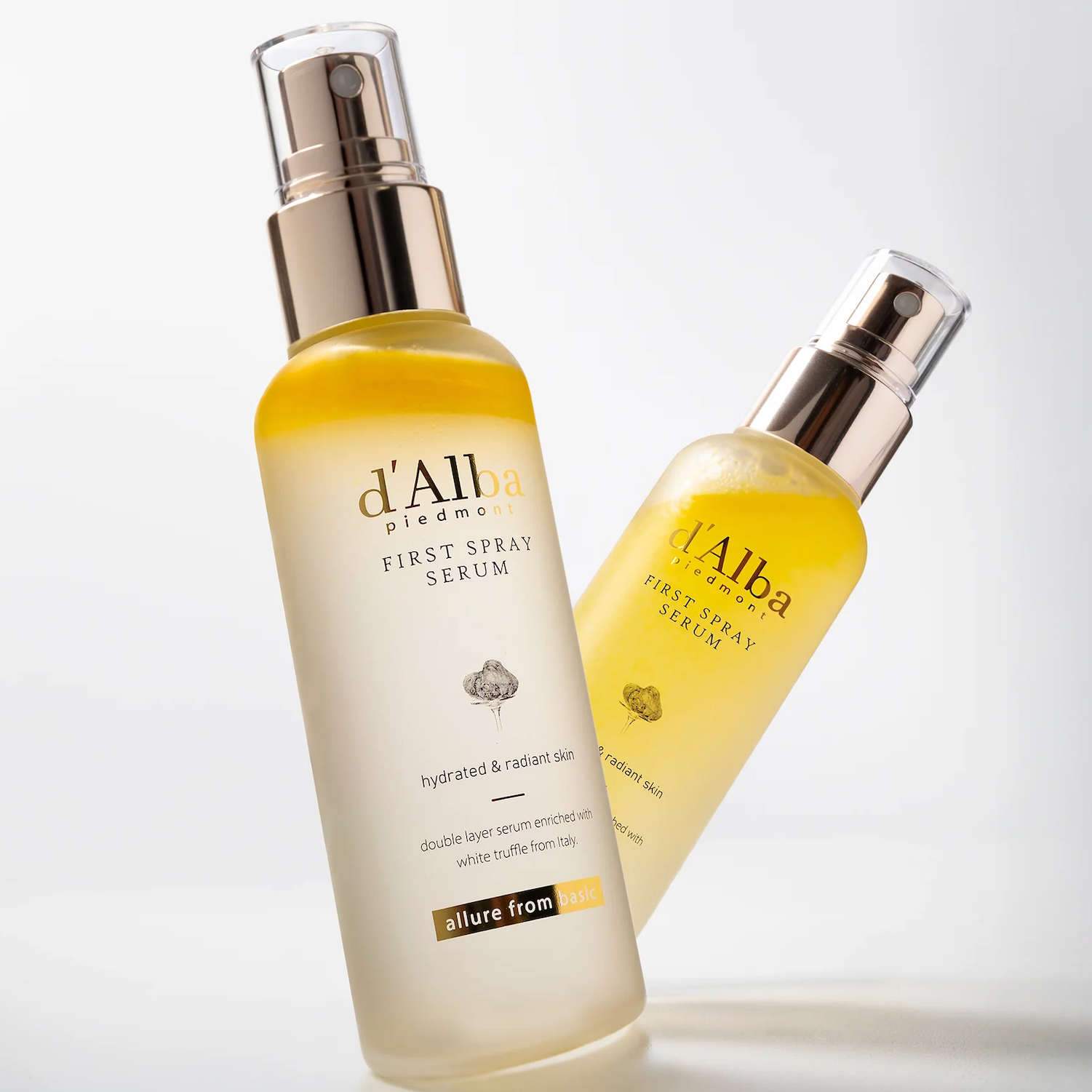 Two bottles of d'Alba First Spray Serum on a light gray background