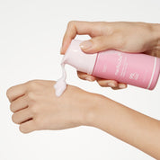 MEDICUBE PDRN Pink Collagen Bubble Serum pump on hand with white background